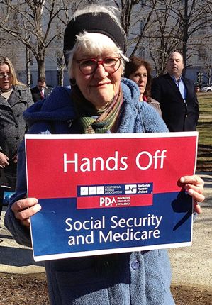 Nurse_holding_red_white_and_blue_sign_-_Hands_Off_Social_Security_and_Medicare