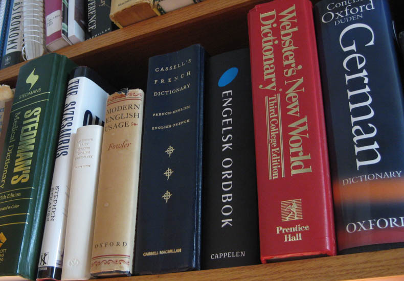 a row of dictionaries on a shelf