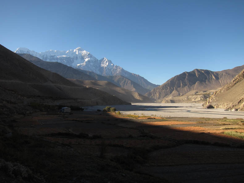 A very tall mountain over a dry river valley