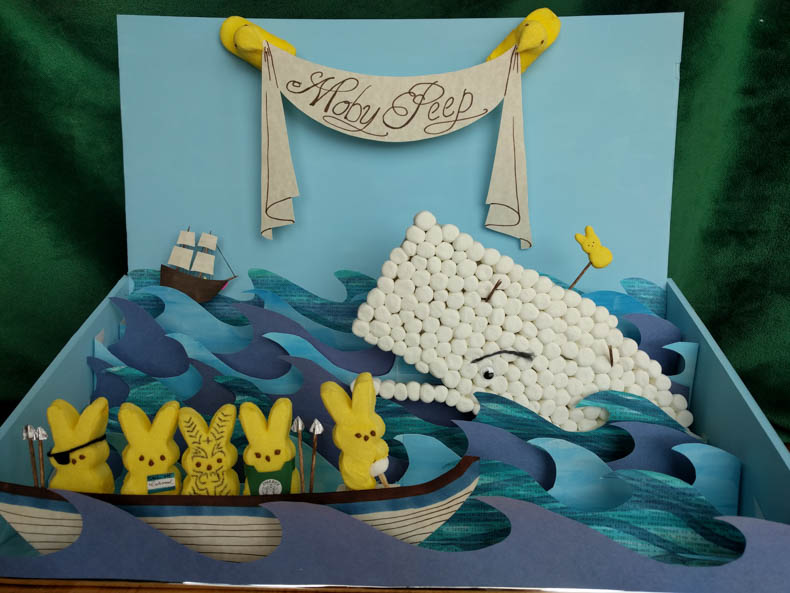 A diorama of Moby Dick, but with marshmallows instead of people and whale.