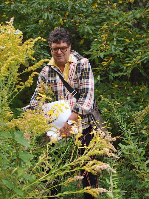 A smiling man with yellow flowers