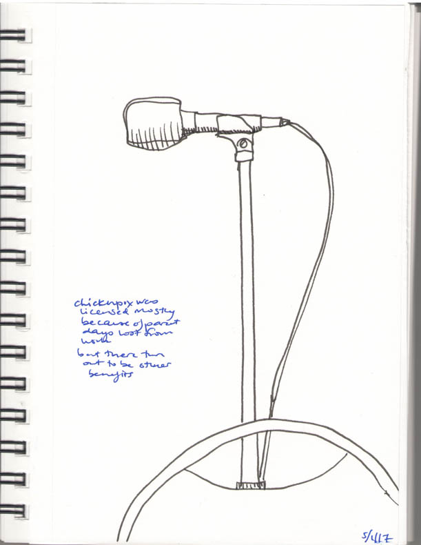 A drawing of a microphone with a chair in front of it