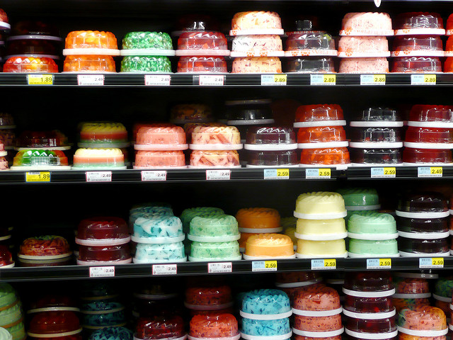 A bunch of florescent jellos on a store shelf