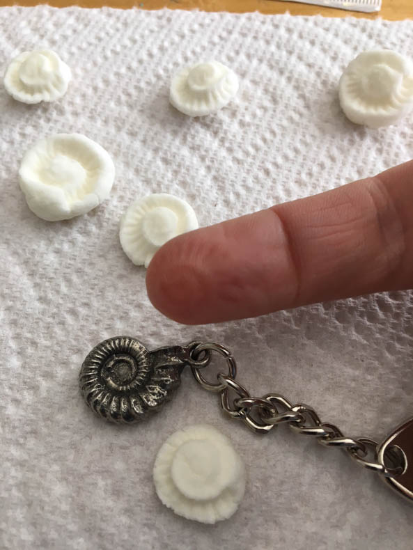 ammonite keychain with finger
