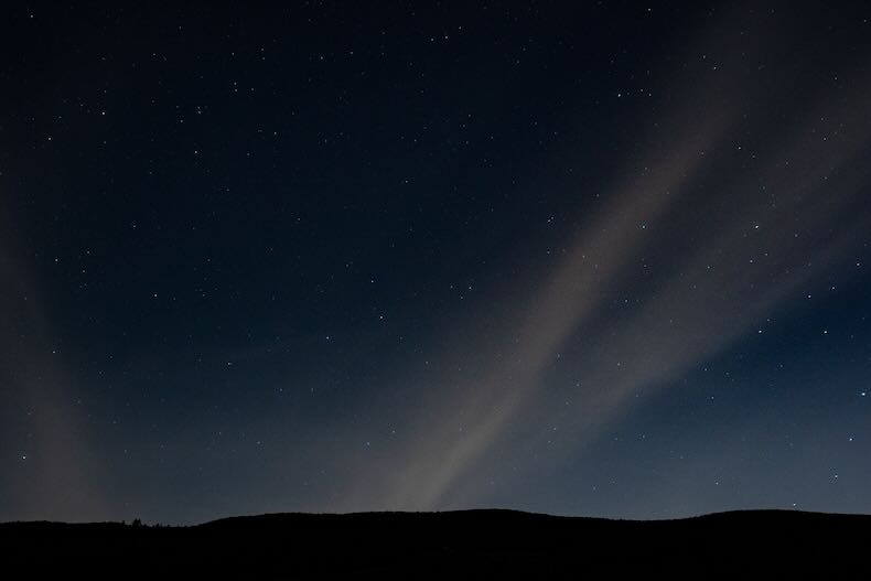 A murky night sky streaked with clouds