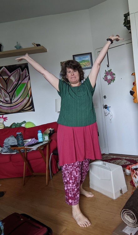 woman in pink dress, green t-shirt, and pink polka dot pants